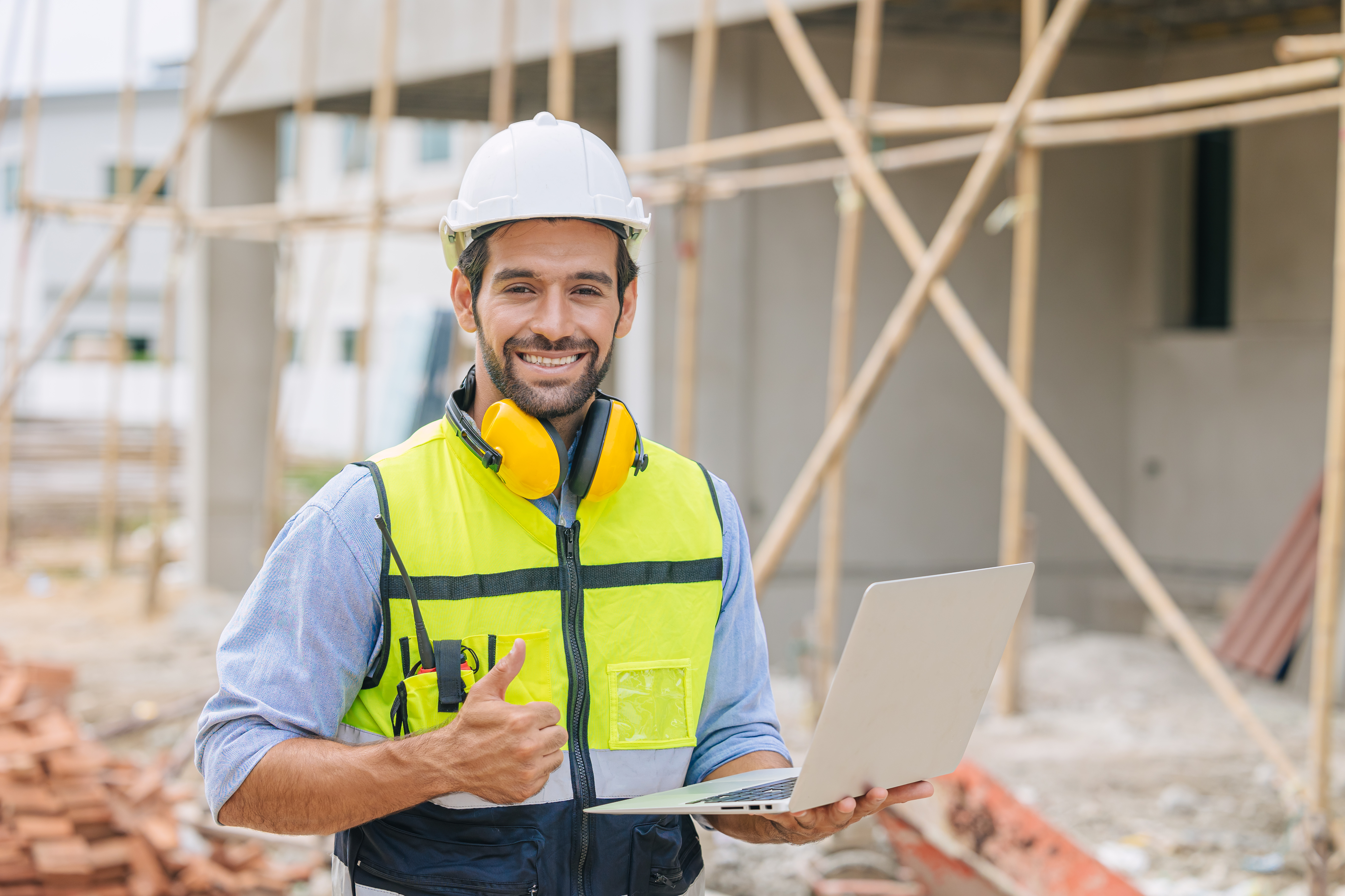 caucasian latin worker foreman home builder hand sign thumbs up for good pass build and safety quality confirm concept.